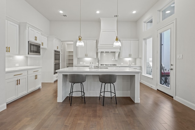 kitchen featuring white cabinetry, hanging light fixtures, and dark hardwood / wood-style flooring