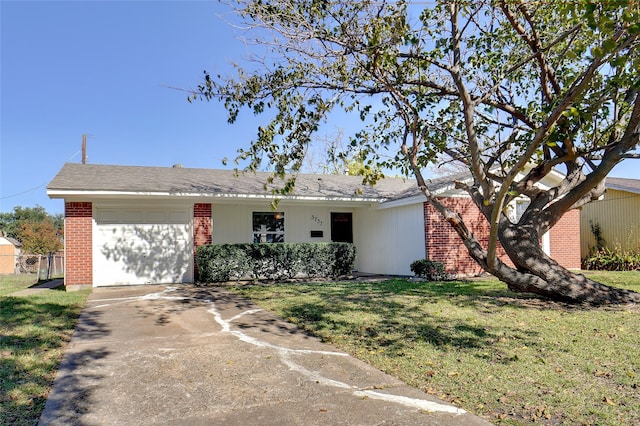 ranch-style house featuring a garage and a front lawn