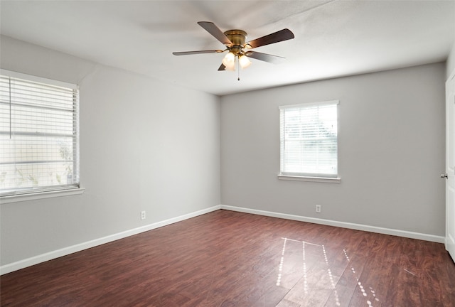 unfurnished room with ceiling fan and dark hardwood / wood-style floors