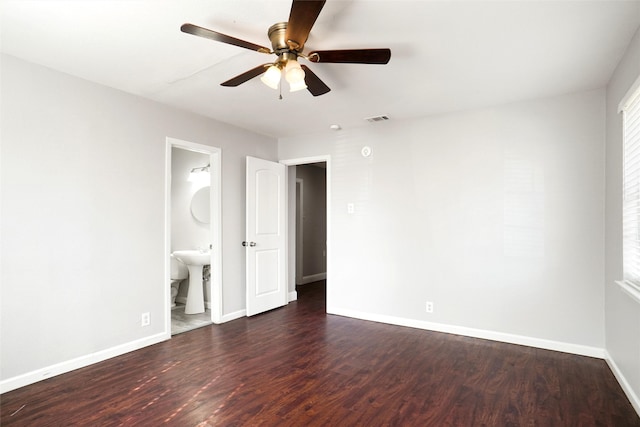 interior space featuring ensuite bath, ceiling fan, dark wood-type flooring, and sink