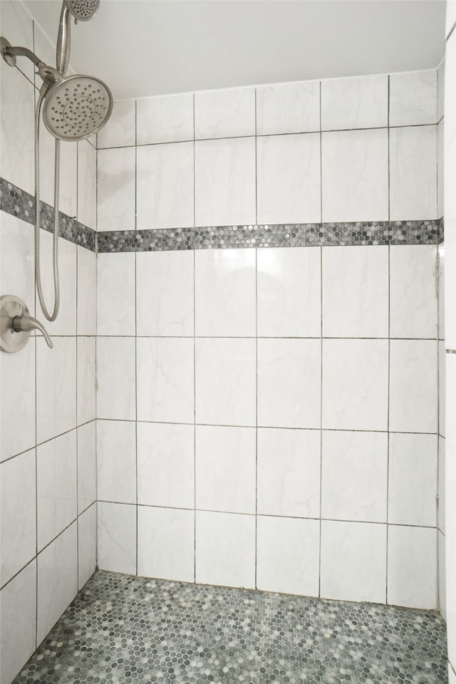 bathroom with tiled shower