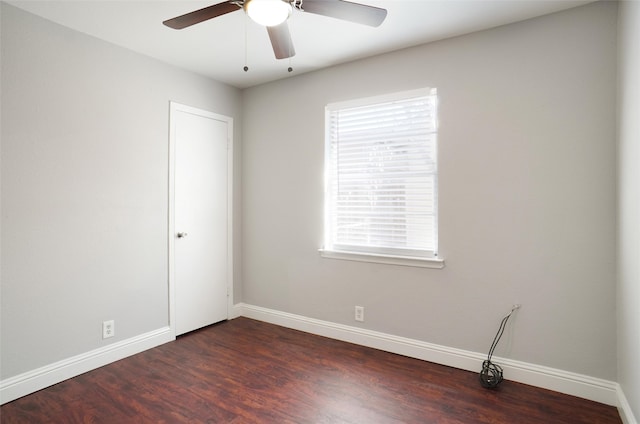 spare room with ceiling fan and dark hardwood / wood-style flooring