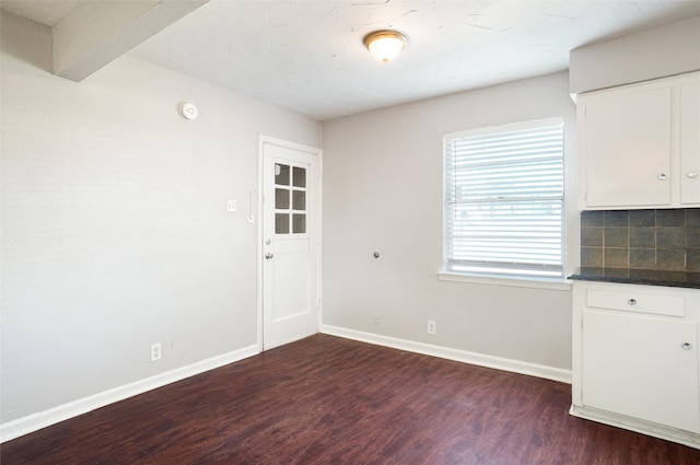 unfurnished dining area with dark hardwood / wood-style floors