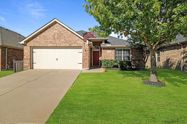 view of front of home with a front yard and a garage