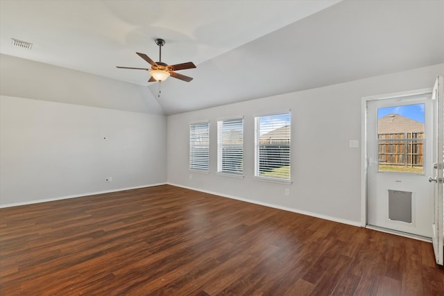 spare room featuring lofted ceiling, dark hardwood / wood-style floors, and ceiling fan