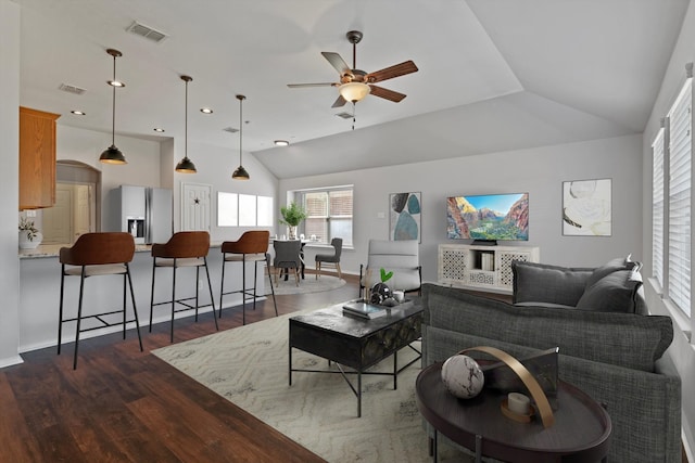 living room featuring lofted ceiling, dark hardwood / wood-style floors, and ceiling fan