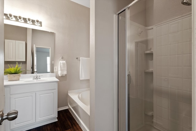 bathroom with vanity, hardwood / wood-style floors, and shower with separate bathtub