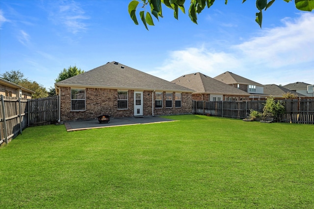 back of house with a yard and a patio