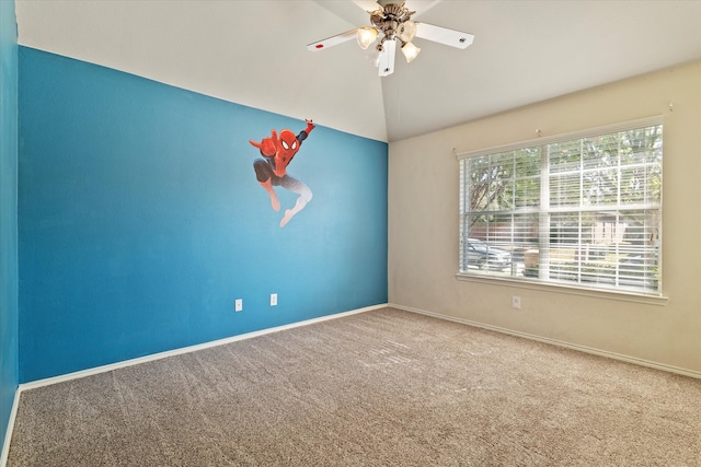 empty room featuring carpet, vaulted ceiling, and ceiling fan