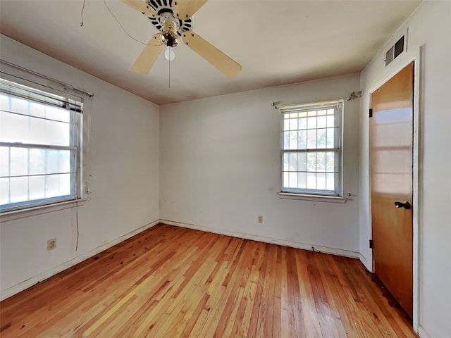 empty room featuring light wood-type flooring and ceiling fan