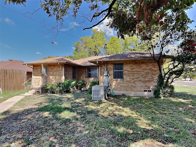 ranch-style house featuring central AC and a front lawn