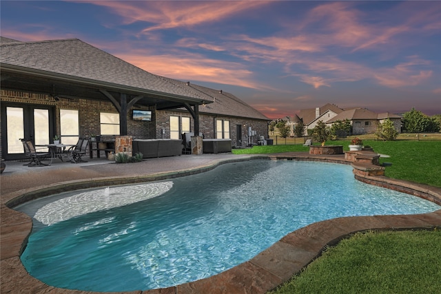 view of swimming pool featuring a patio area and a yard