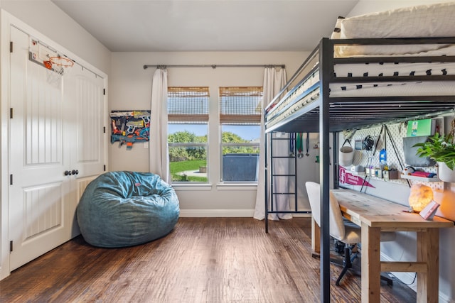 bedroom with dark hardwood / wood-style floors