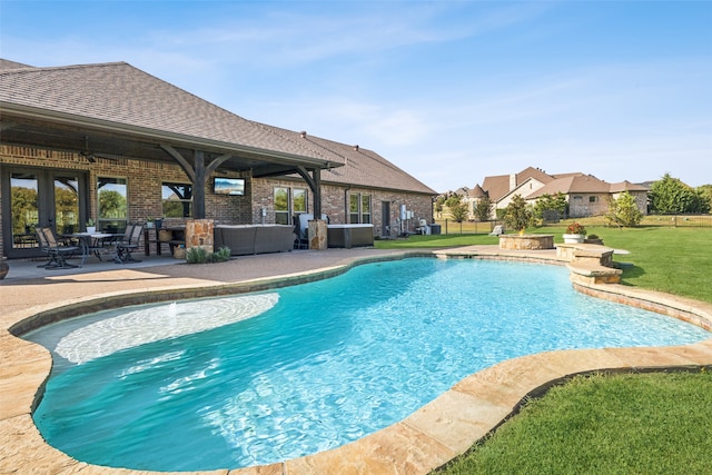 view of swimming pool with a yard, a patio area, and ceiling fan