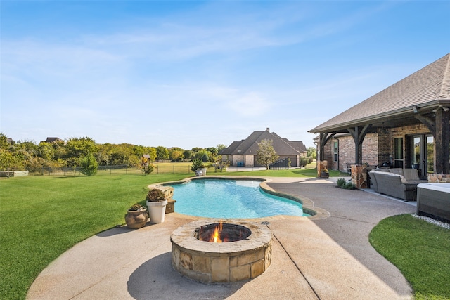 view of swimming pool with an outdoor living space with a fire pit, a patio area, and a lawn