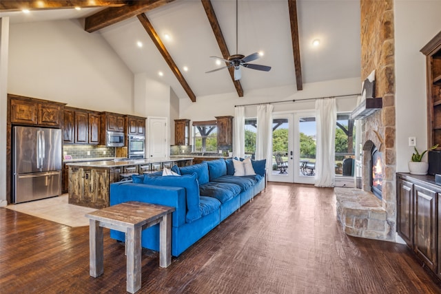 living room featuring ceiling fan, high vaulted ceiling, light wood-type flooring, beamed ceiling, and french doors