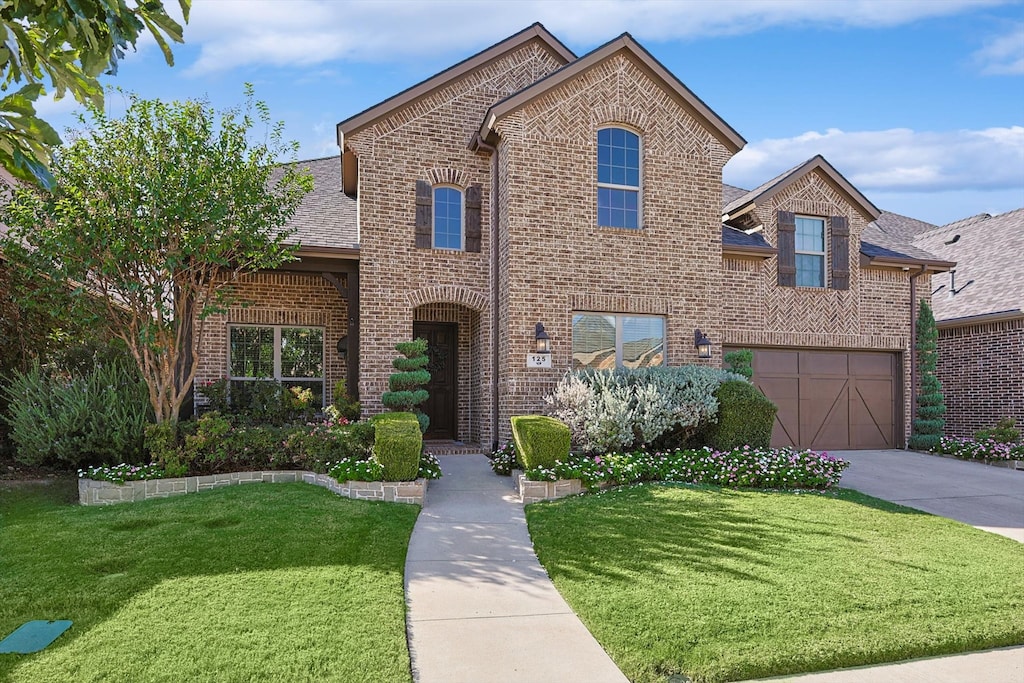 view of front of house with a front lawn and a garage