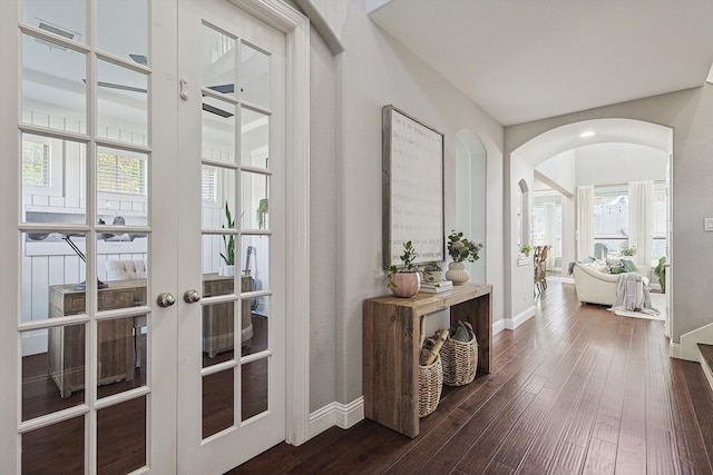 corridor with dark hardwood / wood-style flooring, french doors, and plenty of natural light