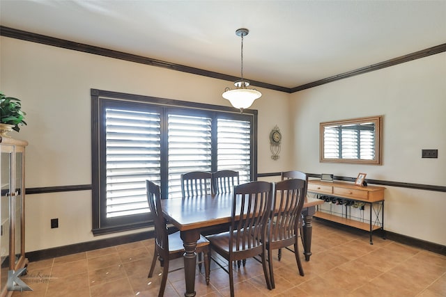 tiled dining room with ornamental molding and a wealth of natural light