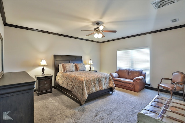 carpeted bedroom with ornamental molding and ceiling fan