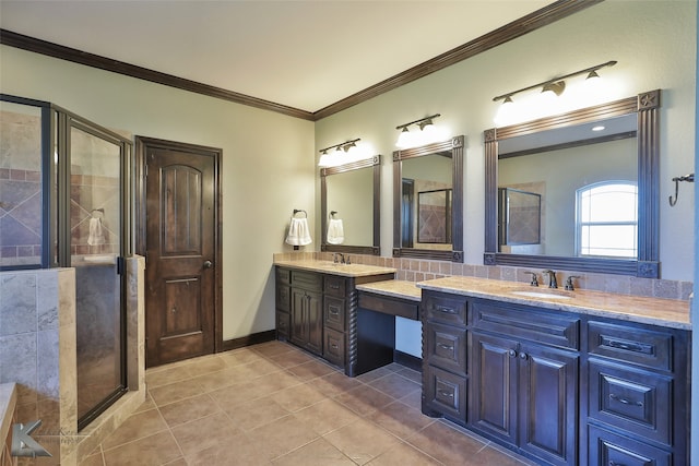 bathroom with a shower with door, crown molding, vanity, and tile patterned floors