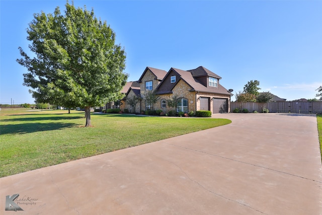 view of front of home with a front lawn and a garage