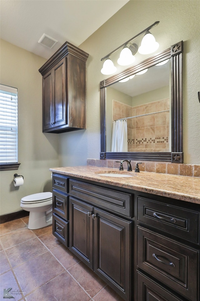 bathroom with vanity, toilet, and curtained shower