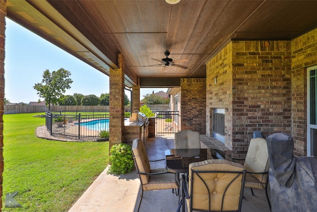 view of patio / terrace featuring a fenced in pool and ceiling fan