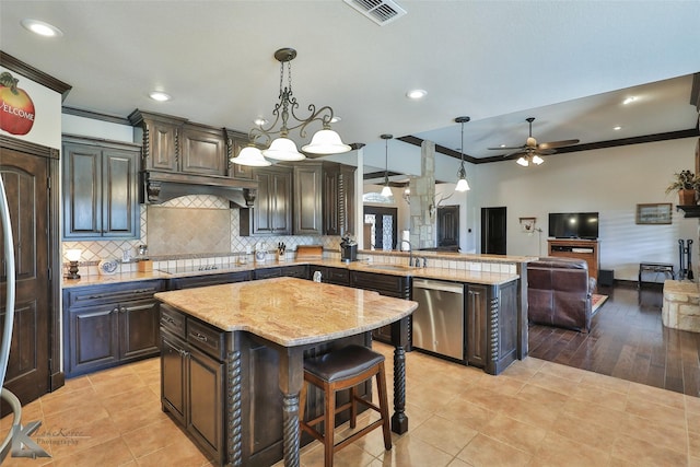 133 Prairie Creek Way, Abilene, TX 79602 - kitchen featuring stainless steel dishwasher, ornamental molding, a sink, a peninsula, and light stone counters