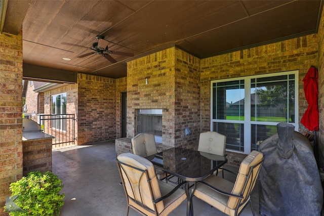 133 Prairie Creek Way, Abilene, TX 79602 - view of patio / terrace with an outdoor brick fireplace, outdoor dining space, exterior kitchen, and ceiling fan