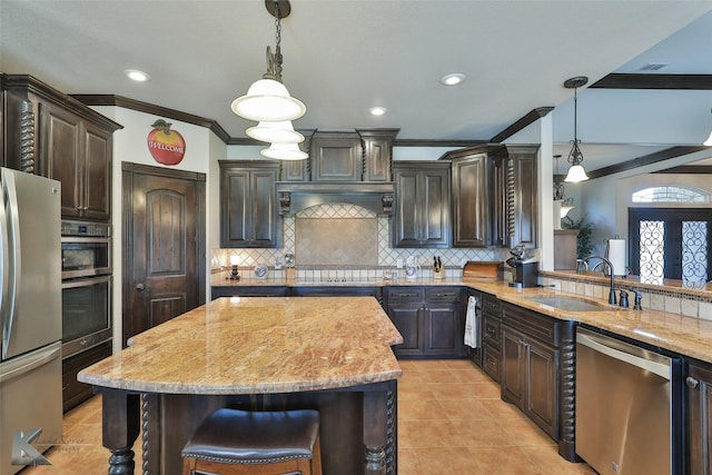 133 Prairie Creek Way, Abilene, TX 79602 - kitchen with stainless steel appliances, a sink, crown molding, dark brown cabinets, and light stone counters