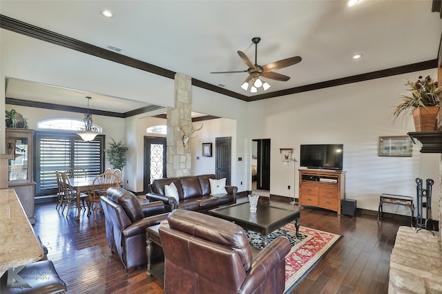 living room featuring crown molding, ornate columns, dark hardwood / wood-style floors, and ceiling fan