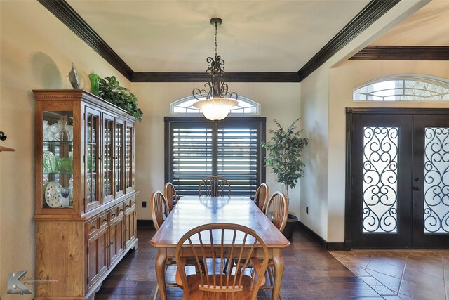 dining room with french doors, crown molding, and plenty of natural light