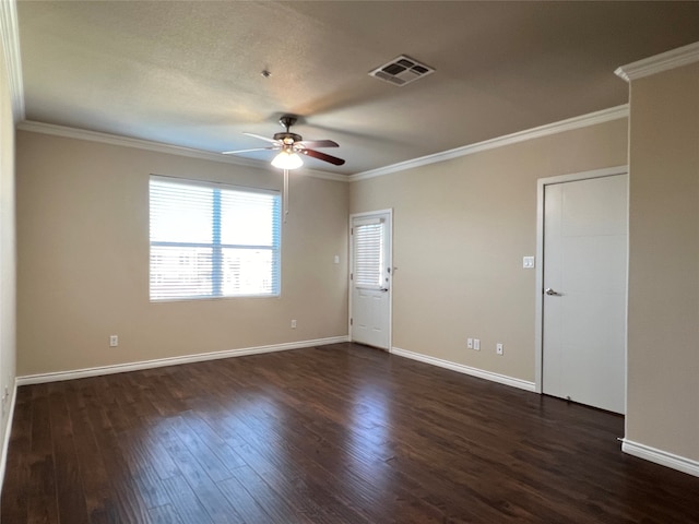 empty room featuring dark wood-type flooring, crown molding, and ceiling fan