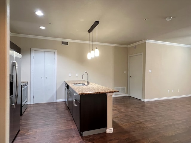 kitchen featuring hanging light fixtures, appliances with stainless steel finishes, dark wood-type flooring, crown molding, and sink