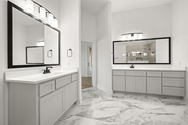 bathroom with a shower, a towering ceiling, and vanity