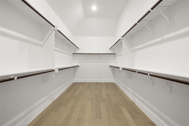 spacious closet with lofted ceiling and light wood-type flooring