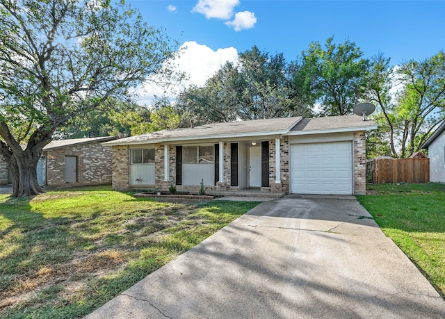 single story home with covered porch, a front yard, and a garage