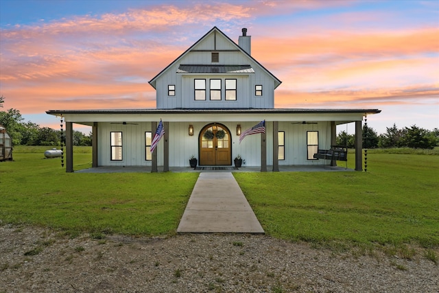 modern inspired farmhouse featuring a lawn and a porch