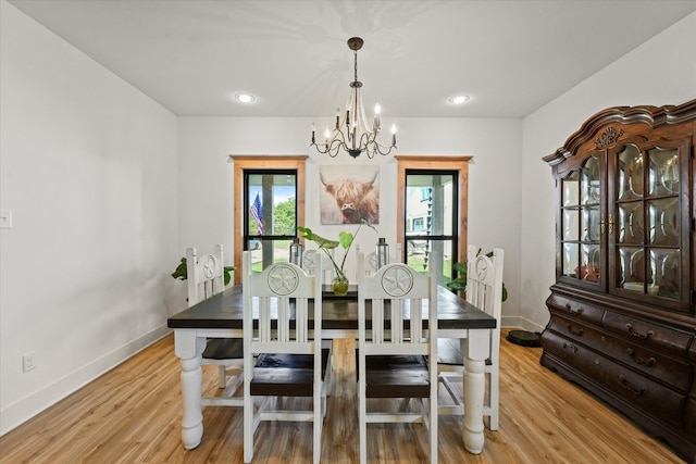 dining room featuring light hardwood / wood-style floors and a chandelier