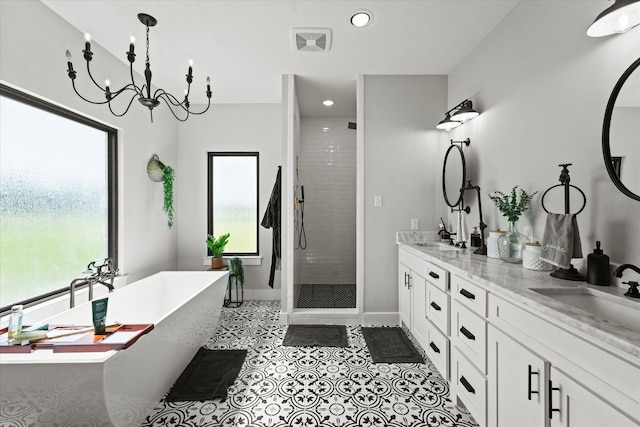 bathroom featuring vanity, independent shower and bath, and a wealth of natural light