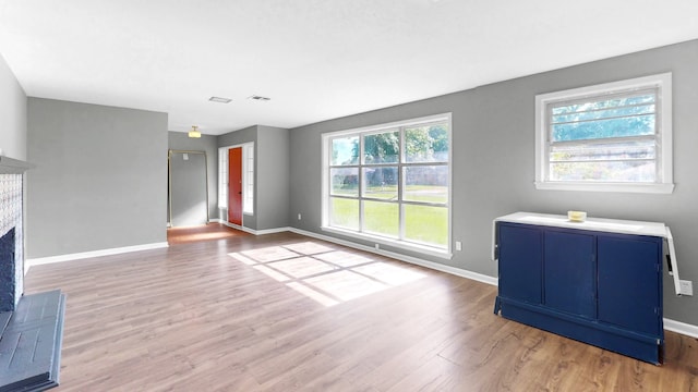 unfurnished living room with hardwood / wood-style flooring