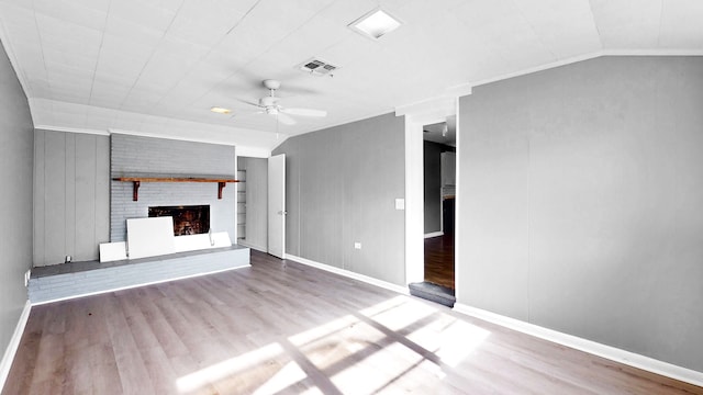 unfurnished living room with light hardwood / wood-style flooring, vaulted ceiling, a fireplace, and ceiling fan