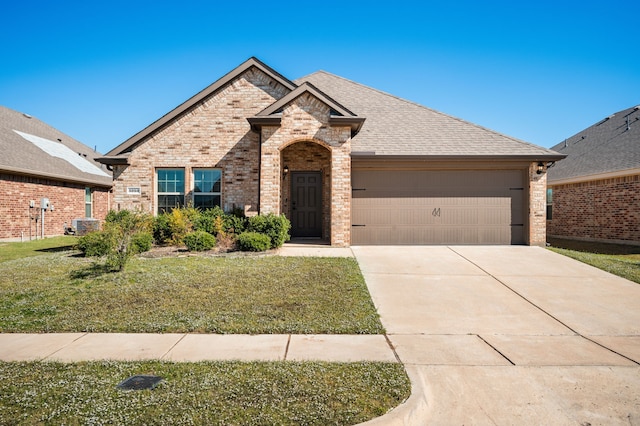 view of front of property featuring a front yard and a garage