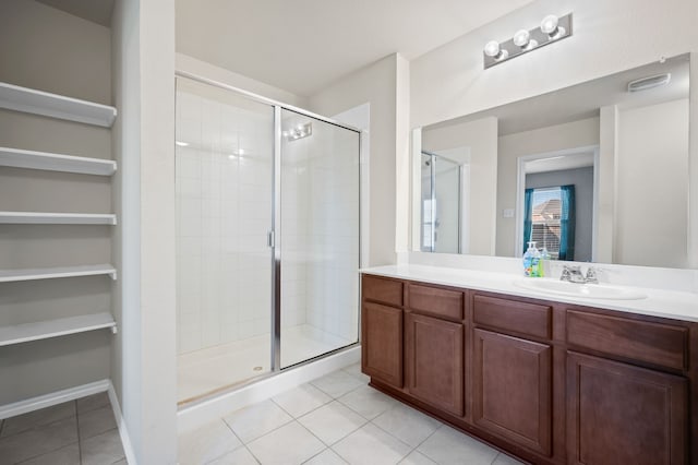 bathroom featuring vanity, an enclosed shower, and tile patterned flooring