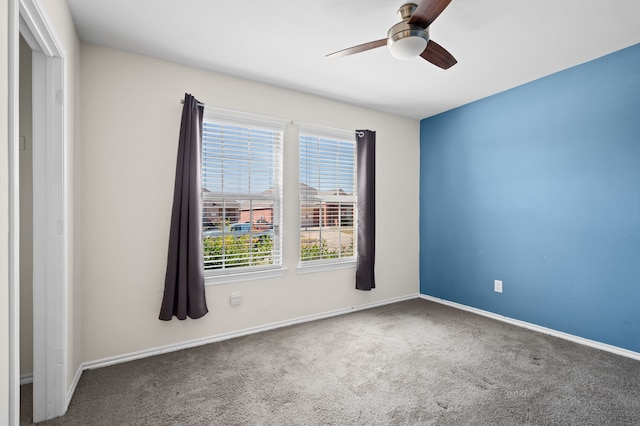 unfurnished room with carpet and ceiling fan