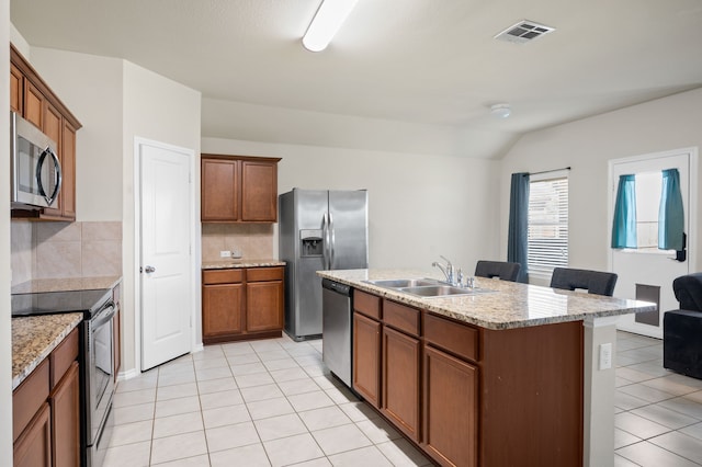 kitchen with stainless steel appliances, tasteful backsplash, sink, and light tile patterned flooring