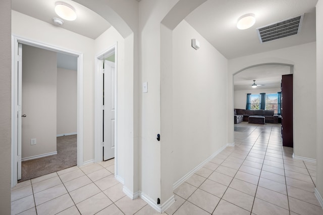 hall featuring light tile patterned flooring