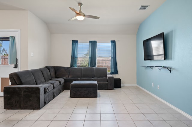 tiled living room with ceiling fan and vaulted ceiling