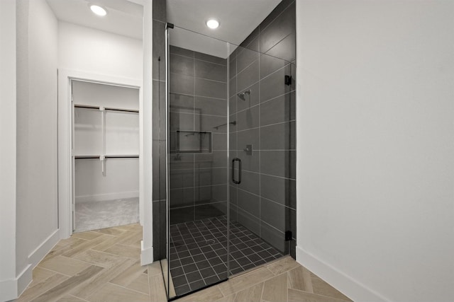 bathroom with a shower with door